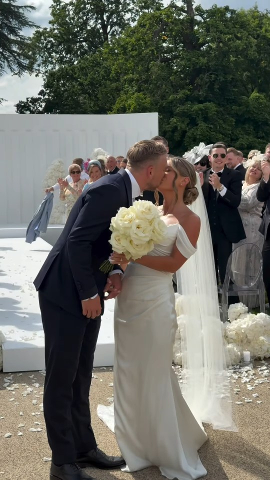 Bride and groom kissing at their wedding.
