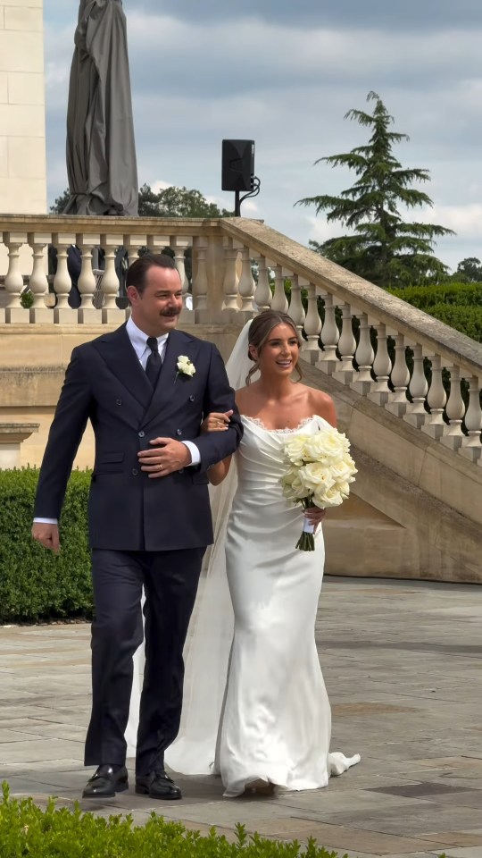 Dani Dyer and her father walking down the aisle at her wedding.