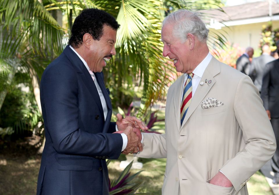 King Charles III shaking hands with Lionel Richie.