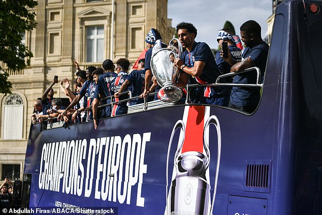 An open top double-decker bus in the PSG colours of blue, red and white, with the words 'Champions D'Europe' written on it, made its way slowly down the Champs Elysees to the Arc de Triomphe.