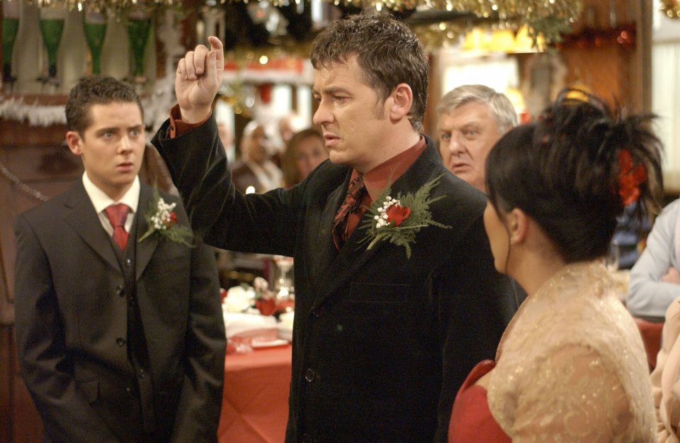 Scene from EastEnders showing a wedding ceremony with Alfie Moon and Kat Slater.