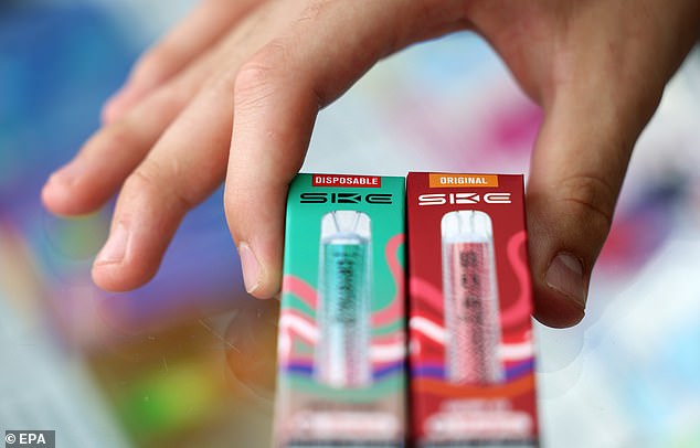 A disposable vape (left) with the new refillable vape (right) are displayed at a store in London -- May 31, 2025