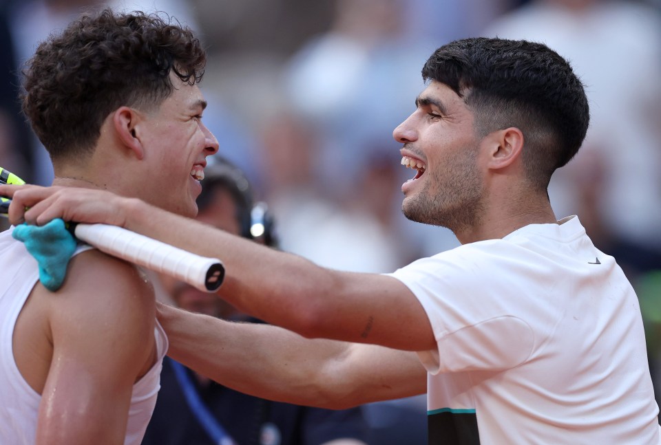 Carlos Alcaraz of Spain hugging Ben Shelton at the net.