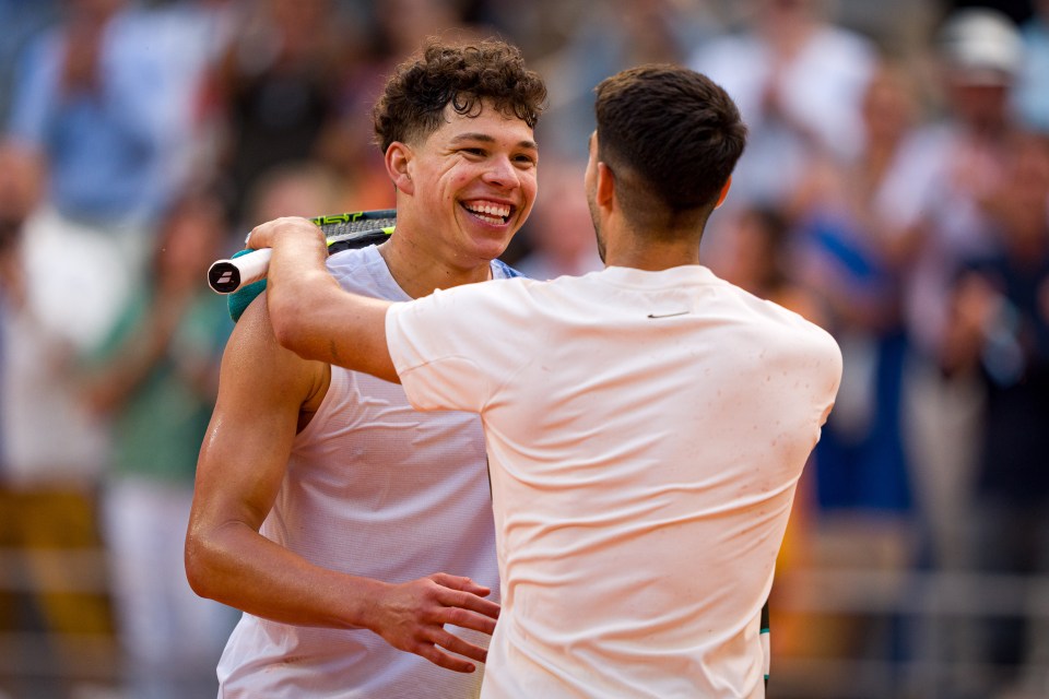 Carlos Alcaraz of Spain and Ben Shelton of the United States embrace after a tennis match.