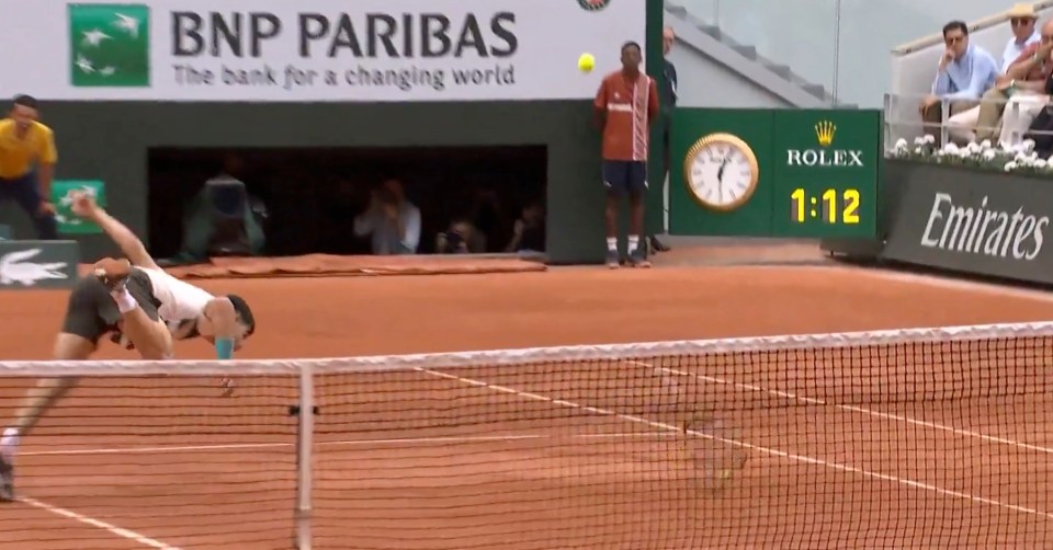 Tennis player diving for a shot.