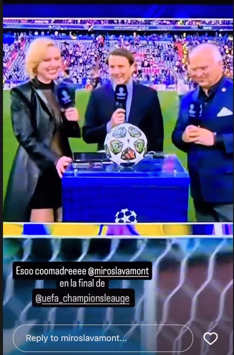 Three sportscasters with microphones stand at a table with the UEFA Champions League trophy.