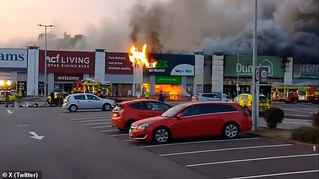A huge emergency response saw 11 fire crews and appliances, along with two aerial teams, tackle the major fire, with road closures also in place