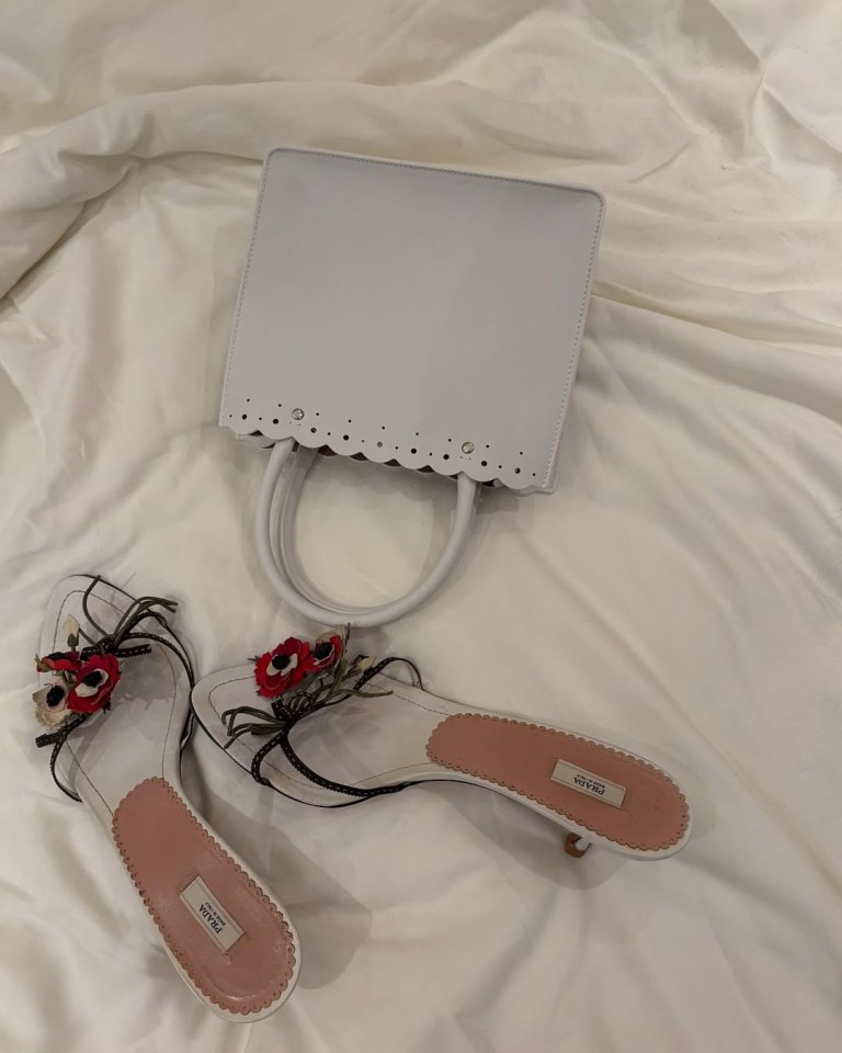 White Prada sandals and handbag.