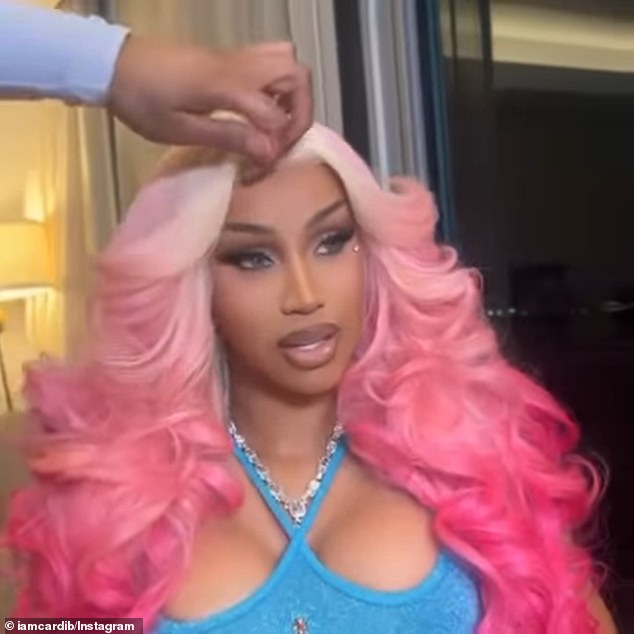 And Cardi B also shared another video of herself singing while getting her hair and makeup done, looking otherworldly with blonde and pink ombré curls and a bright blue halter top