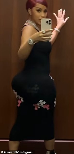 She showed off her hourglass figure while her boyfriend stood to the side