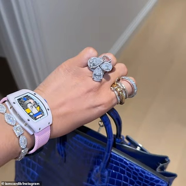 She also showed off more of what appeared to be more lavish gifts as she included a clip of herself flaunting the sparkling diamonds on her wrist and hands as she held a bright blue Birkin bag
