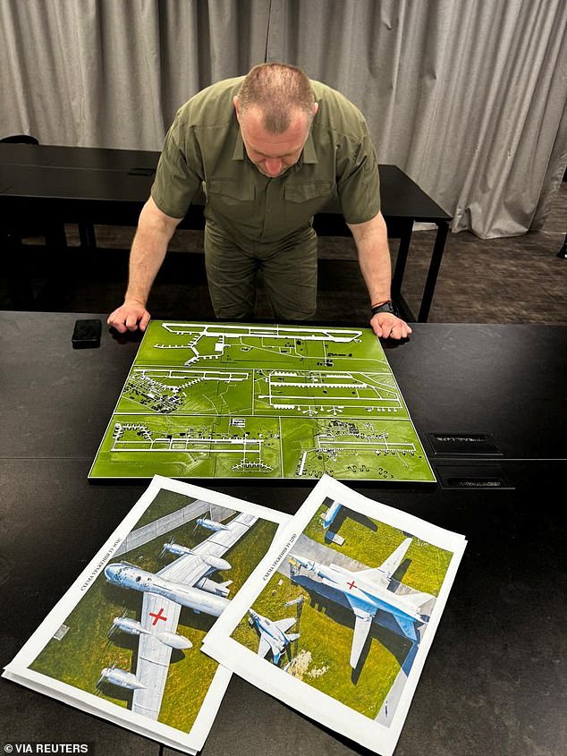 Head of the Ukraine's Security Service Vasyl Maliuk looks at a map of an airfield, amid Russia's attack on Ukraine, in an unknown location in Ukraine