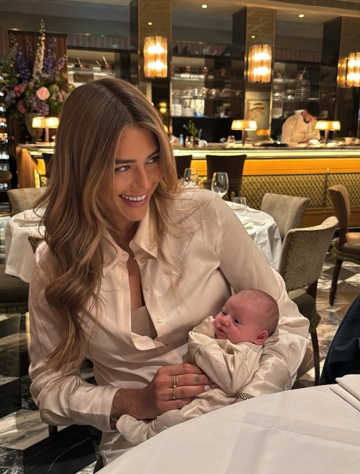 Arabella Chi holding her newborn baby.