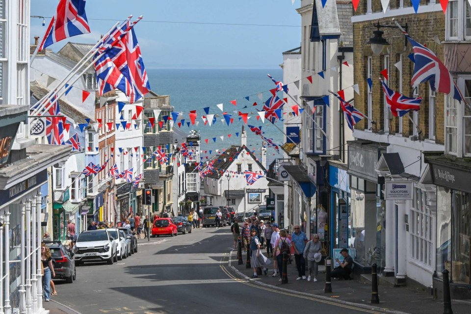 Street scene in Lyme Regis, Dorset, UK, decorated with Union Jack flags and bunting.