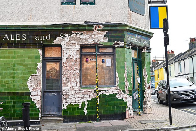 Charlie Southall hired a team of workers who took a pneumatic drill to the historic glazed green tiles of the locally listed pub (above)