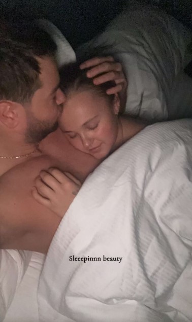Couple cuddling in bed.