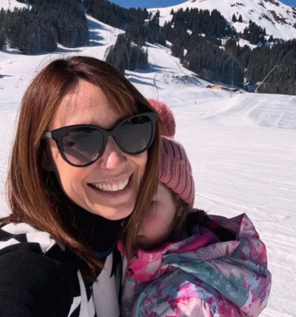 Alex Jones with her daughter Annie at a ski resort.