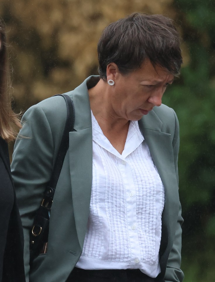 A woman in a green jacket and white shirt leaves court.