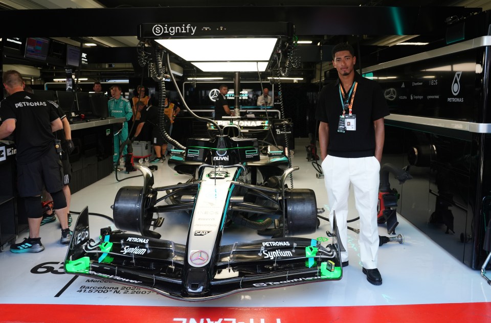 Jude Bellingham standing in the Mercedes garage.
