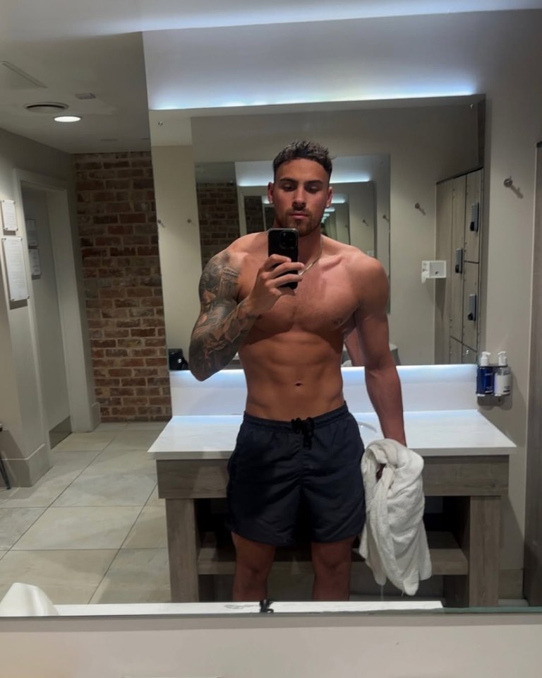 Man taking a selfie in a gym locker room.