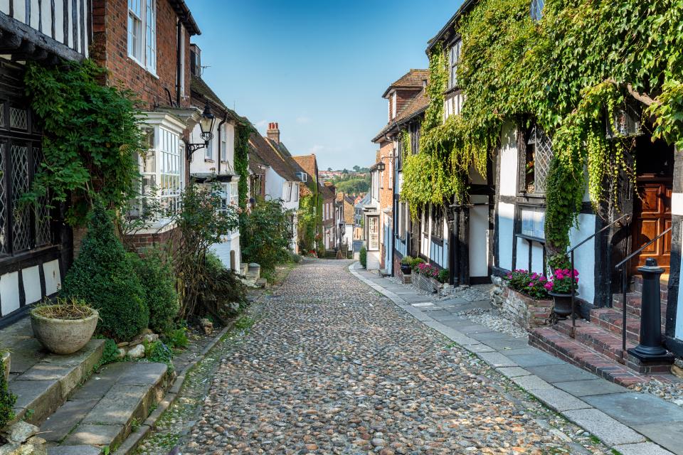 Cobblestone street in Rye, lined with historic buildings.