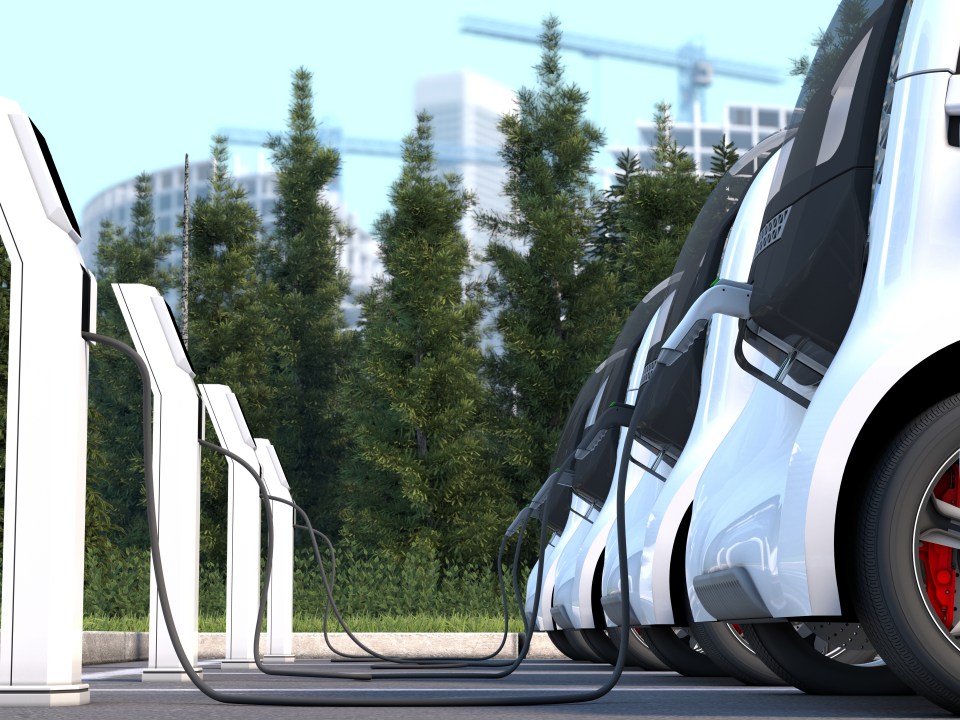 Illustration of electric cars charging at a charging station.
