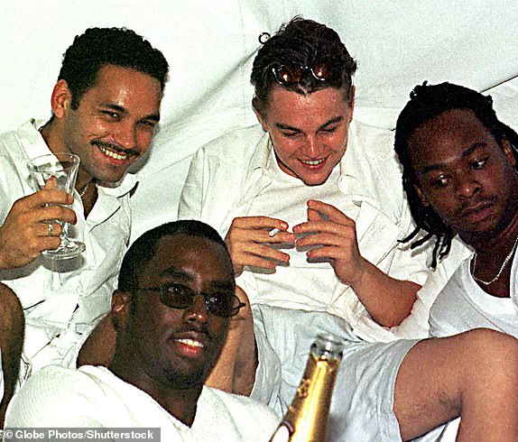 Mandatory Credit: Photo by Globe Photos/Shutterstock (14731265b) East Hampton, NY--August 29, 1998--.Sean ''Puffy'' Combs (front center) and Leonardo DiCaprio .(back center) pose for pictures at Combs labor day party at .his house in East Hampton, NY..CREDIT: .I2627CKO...CREDIT: NAME/ P Diddy Hamptons Labor Day Party 1998, East Hamptons, New York, USA - 07 Sep 1998