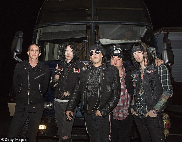 Downe is the lead vocalist of the iconic 80s metal band - pictured 2013 with Xristian Simon, Danny Nordahl, and Ace Von Johnson