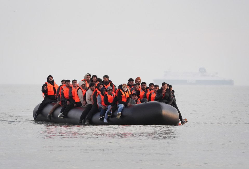 Migrants in a small boat at sea.