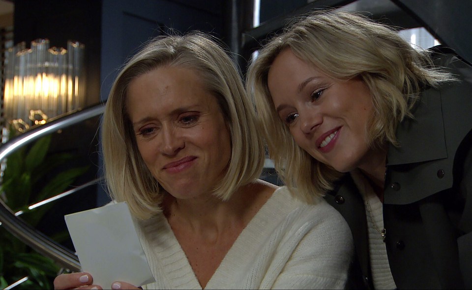 Two women looking at a photograph.