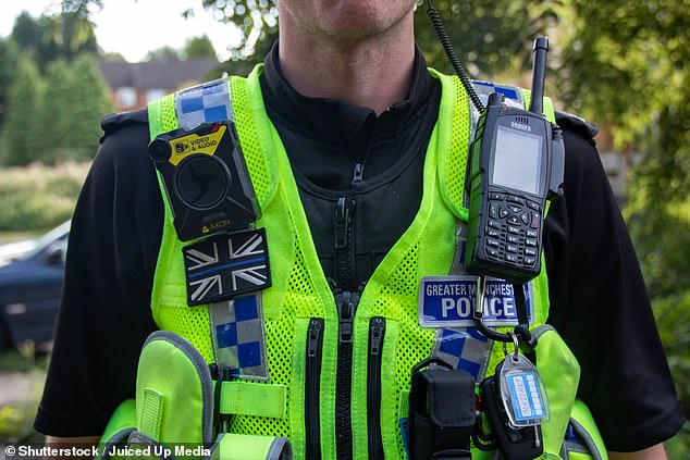 It emerged the group had been selling Class A drugs across Greater Manchester 'relentlessly'. Pictured: Officer at Greater Manchester Police wearing a hi vis equipment vest