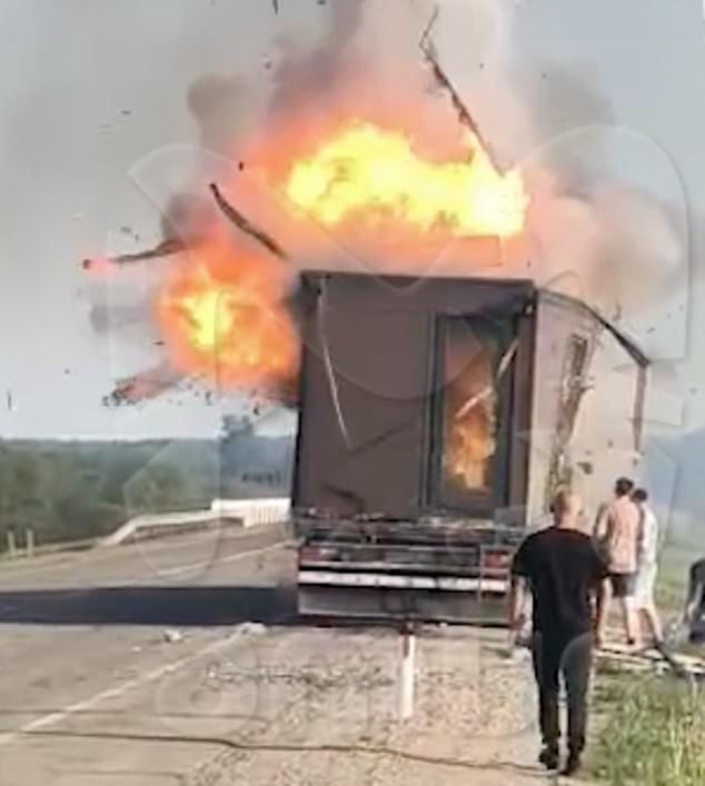 The explosion seen from a road as bystanders are stopped in their tracks