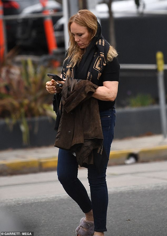 Bach wore natural looking makeup and accessorized with a quilted Chanel purse and a black and brown patterned scarf