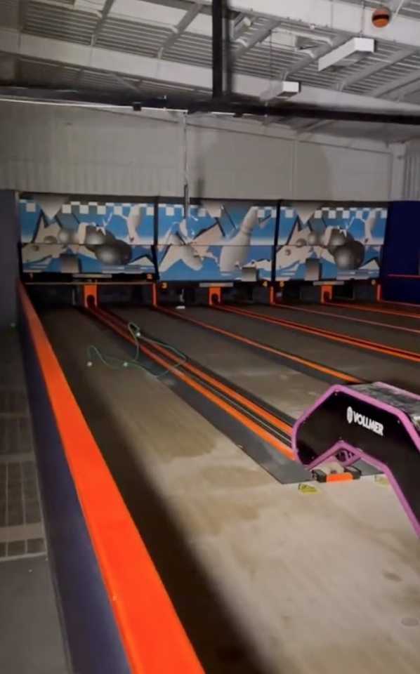 Interior view of an abandoned water park with a children's play area and pool.