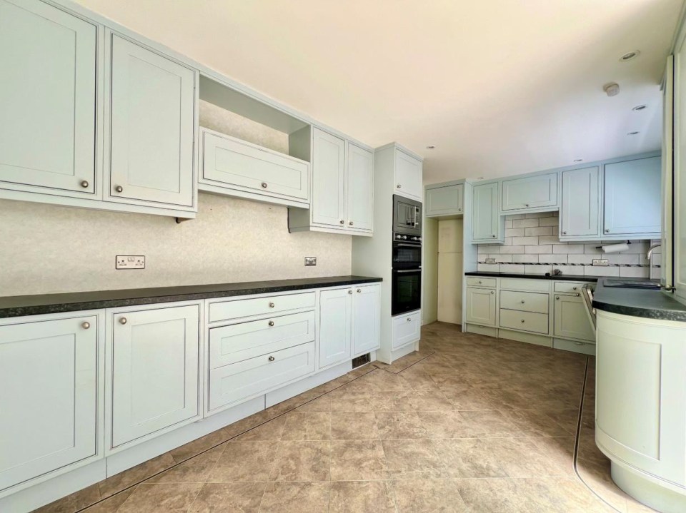 Interior view of a light blue kitchen.