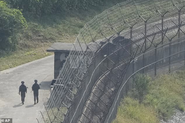 Thousands of USB sticks and SD cards containing South Korean television shows, music, and movies are smuggled over the North Korean border (pictured) each month. But Kim Jong Un is now cracking down on this practice with harsher punishments for those caught with foreign media