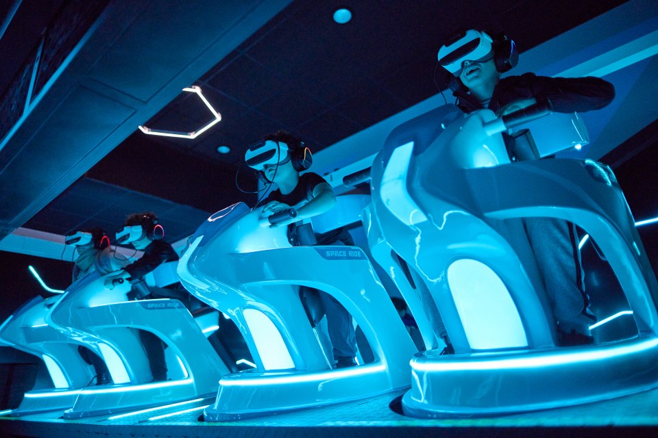 People wearing VR headsets on a Space Ride.