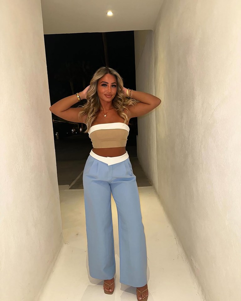 Woman in beige and light blue outfit.