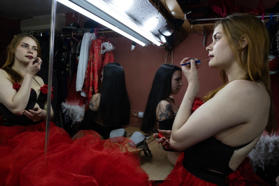 Flash Dancers club dancers in Kharkiv, Ukraine, applying makeup in a dressing room.