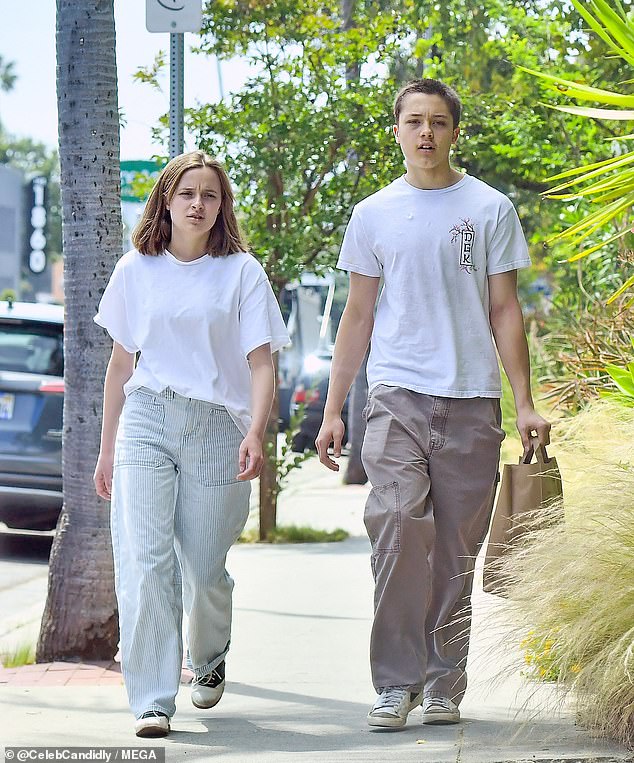 Knox resembled a young Pitt with his shaved head - with the nepo-baby clad in a white top and grey joggers as he headed to the grocery store