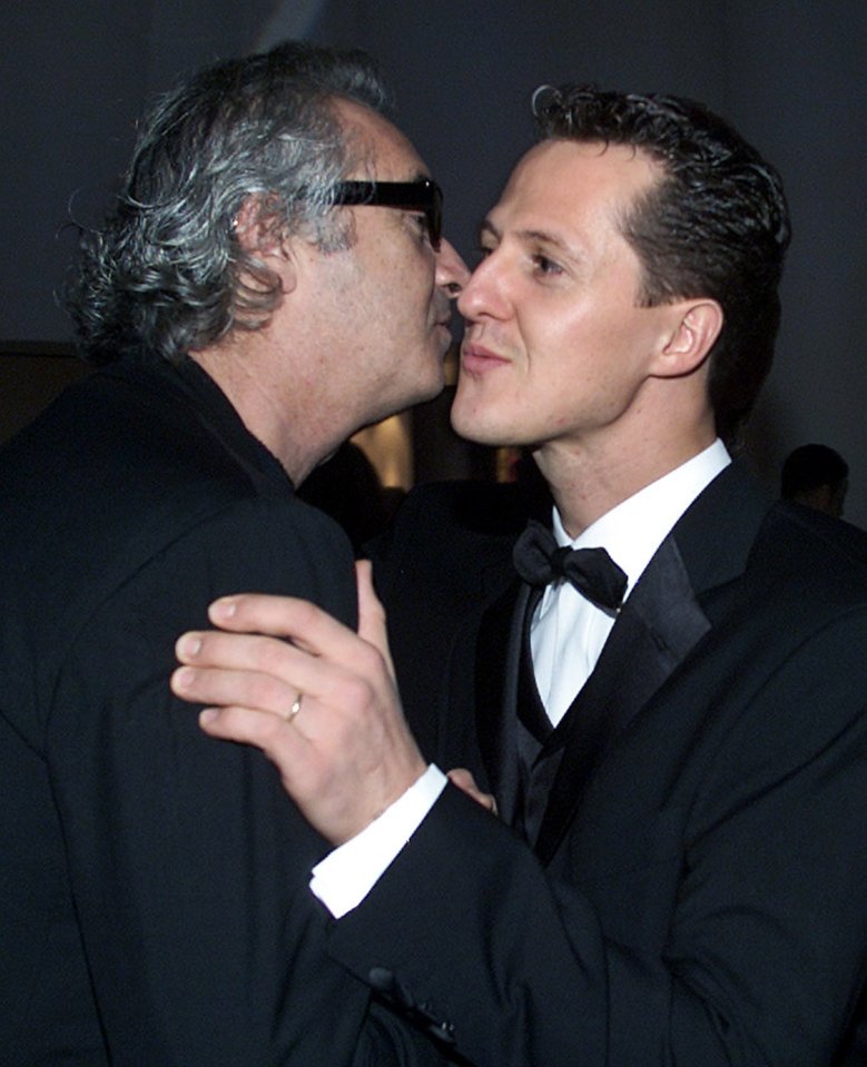 Michael Schumacher kissing his former team manager Flavio Briatore.