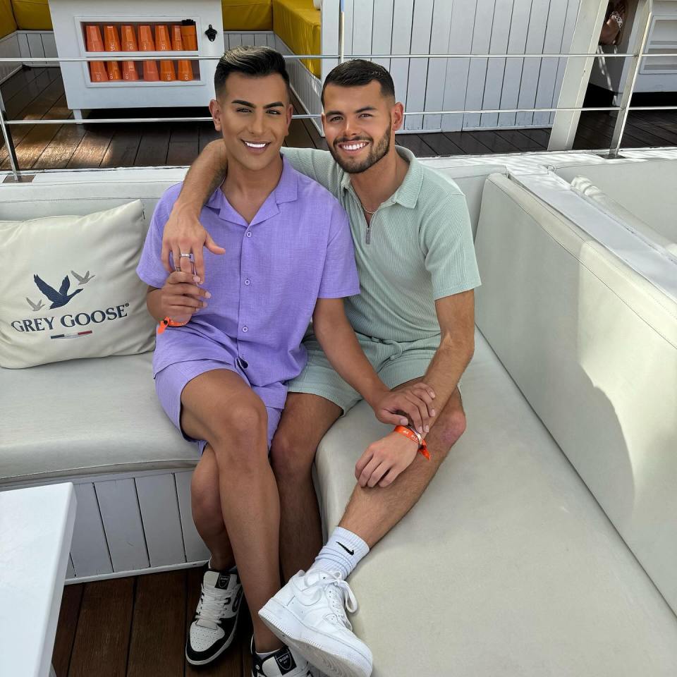 Two men sitting on a couch together.