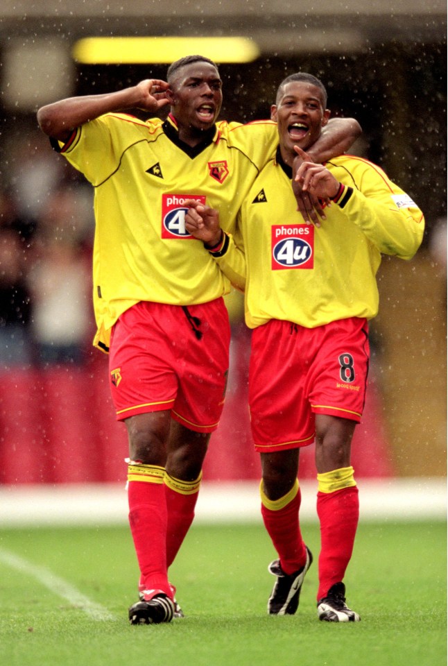 Two Watford soccer players celebrating a goal.
