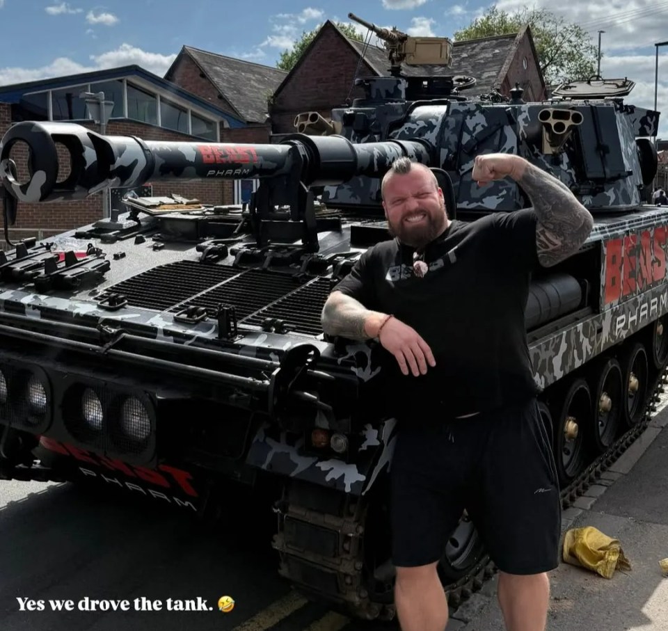 Eddie Hall with a camouflaged tank.