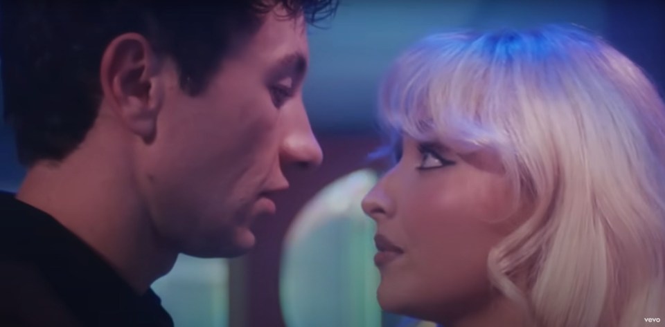 Sabrina Carpenter and Barry Keoghan in a music video scene.