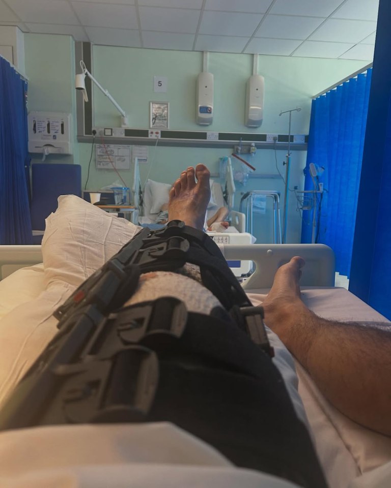 Leg in a knee brace in a hospital bed.