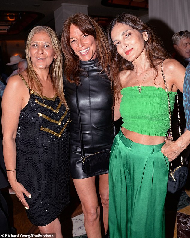 Davina, 57, looked sensational in a black leather mini dress as she made sure to put on a very leggy display in her outfit (pictured with Azzi Glasser and Yasmin Mills)
