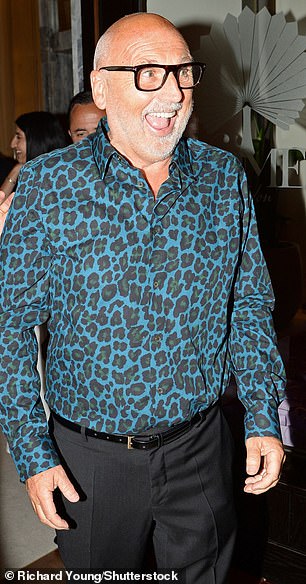 The hairstylist opted for a bold blue leopard print shir