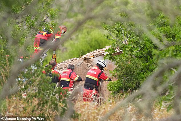 Firefighters and search teams check a well at a derelict and abandoned property to the west of Praia De Luz, Portugal, where searches are being carried out by officers investigating the disappearance of Madeleine McCann