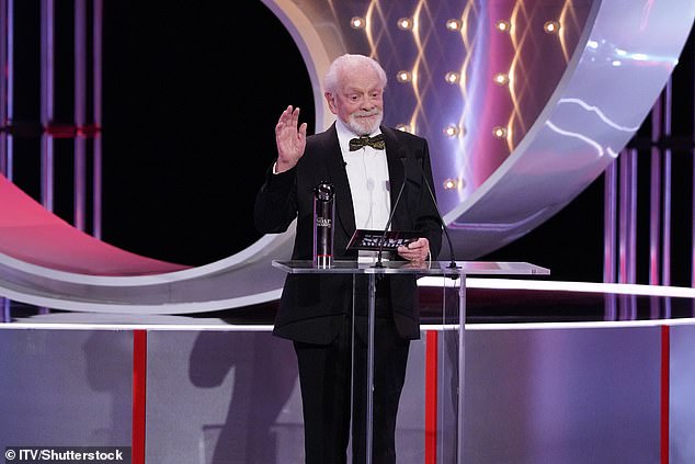 The Only Fools and Horses star, 85, cut a dapper figure in a classic black suit and bow tie as he announced EastEnders as the winner